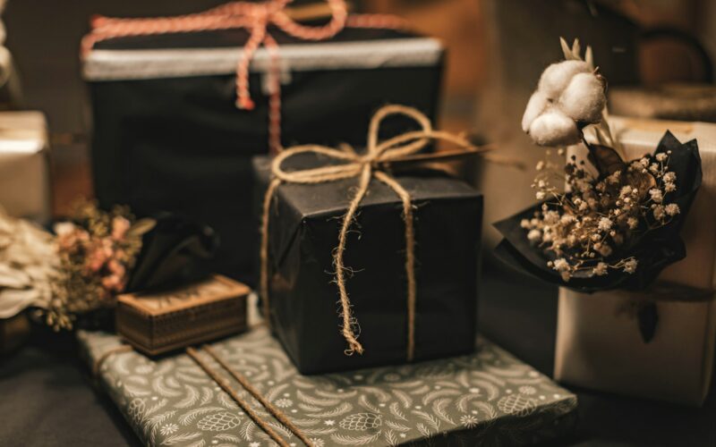 black and brown gift box on white and black floral textile